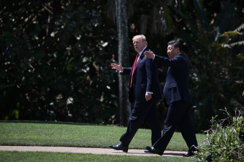 President Donald Trump and Chinese leader Xi Jinping walk along the front patio of the Mar-a-Lago estate after a bilateral meeting in Palm Beach, Fla., on April 7, 2017. (REUTERS/Carlos Barria)