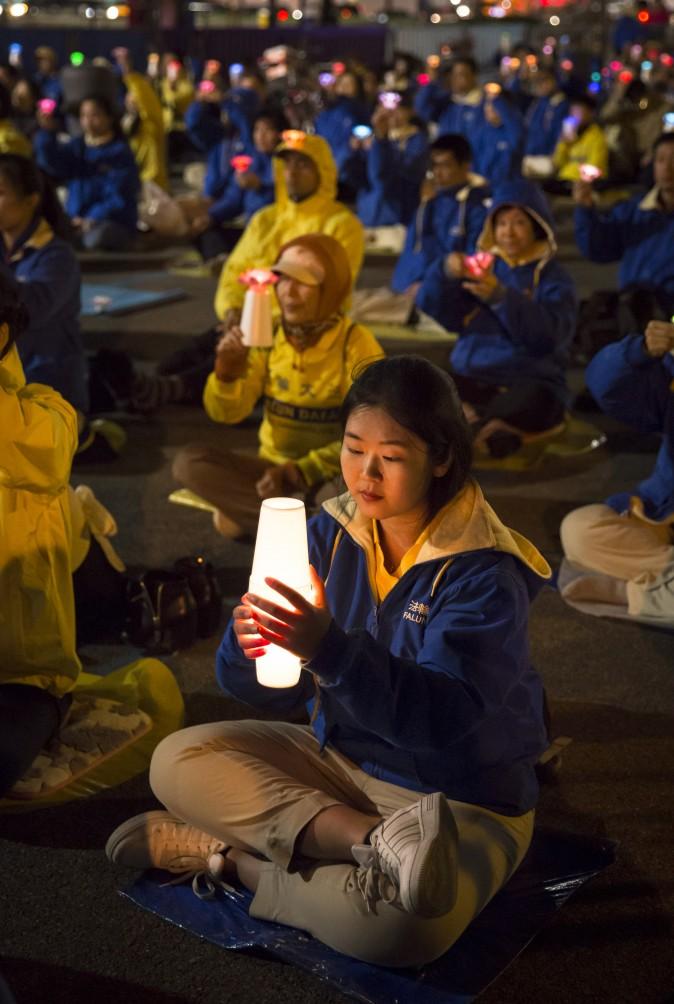Falun Gong practitioners attend a candlelight vigil near the Chinese Consulate in New York on April 23, 2017. (Samira Bouaou/The Epoch Times)