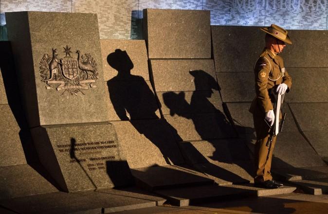 The shadow of a soldier falls on the Australian War Memorial during an Anzac Day dawn service at the Australian War Memorial in London, England, on April 25, 2017. The annual event marks the anniversary of Australia and New Zealand first seeing military action during the First World War. (Dominic Lipinski - WPA Pool /Getty Images)