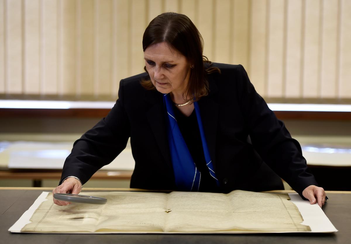 West Sussex County Archivist, Wendy Walker looks at a rare handwritten copy of the U.S. Declaration of Independence at the West Sussex Record Office in Chichester in south England, Britain on April 27, 2017. (REUTERS/Hannah McKay)