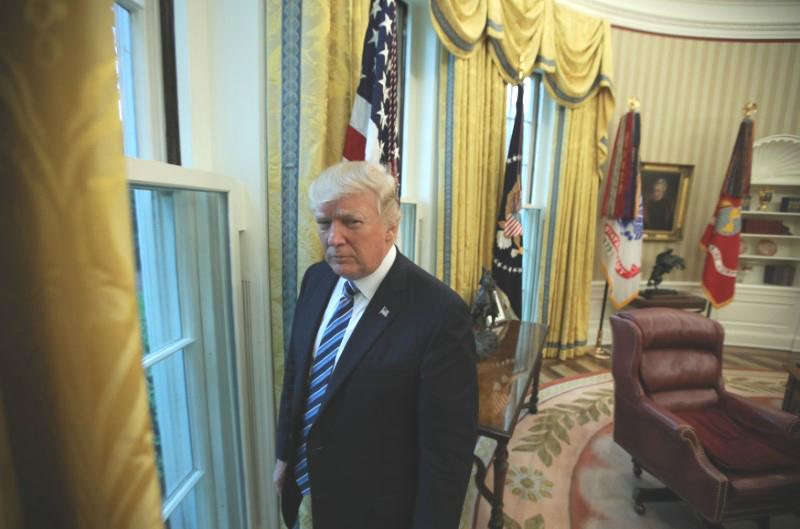 President Donald Trump stands in the Oval Office following an interview with Reuters at the White House in Washington on April 27, 2017. (REUTERS/Carlos Barria)