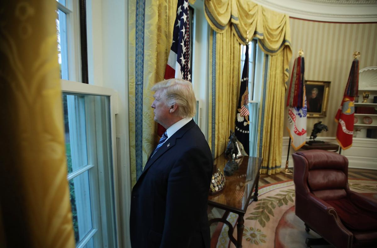 President Donald Trump looks out a window of the Oval Office following an interview with Reuters at the White House in Washington on April 27, 2017. (REUTERS/Carlos Barria)