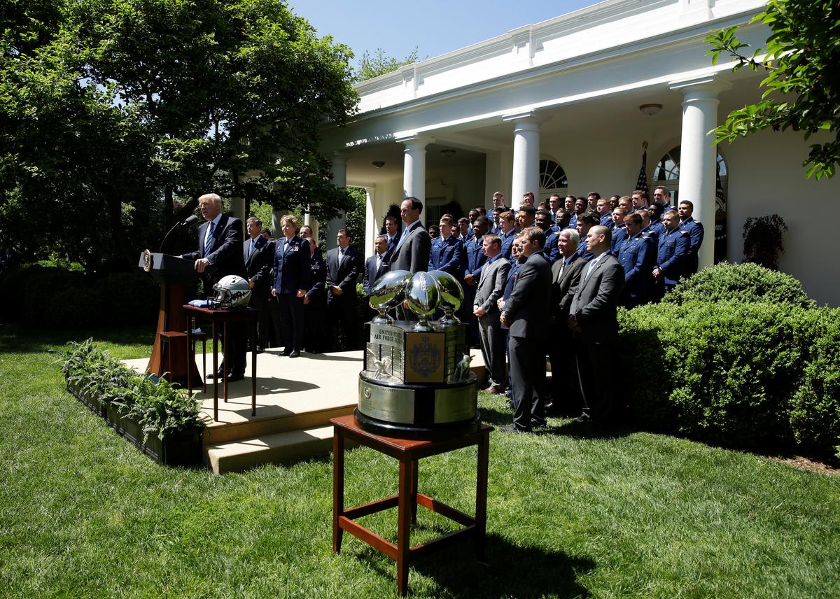 President Donald Trump presents the U.S. Air Force Academy football team with the Commander-in-Chief trophy in the Rose Garden of the White House in Washington on May 2, 2017. (REUTERS/Joshua Roberts)