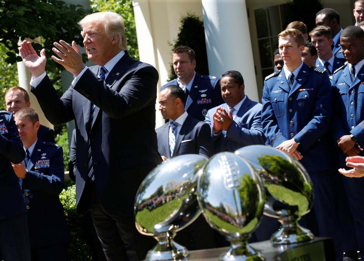 President Donald Trump applauds the U.S. Air Force Academy football team as he presents them with the Commander-in-Chief trophy in the Rose Garden of the White House in Washington on May 2, 2017. (REUTERS/Joshua Roberts