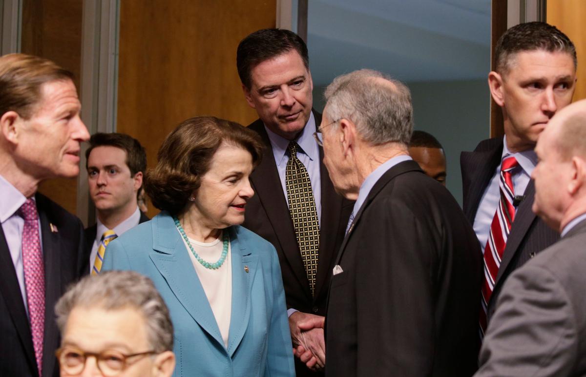 FBI Director James Comey (C) is greeted by ranking member Sen. Dianne Feinstein (D-CA) (3rdL) and Committee Chairman Chuck Grassley (R-IA) (3rdR) as he arrives to testify before a Senate Judiciary Committee hearing on "Oversight of the Federal Bureau of Investigation" on Capitol Hill in Washington on May 3, 2017. (REUTERS/Kevin Lamarque)