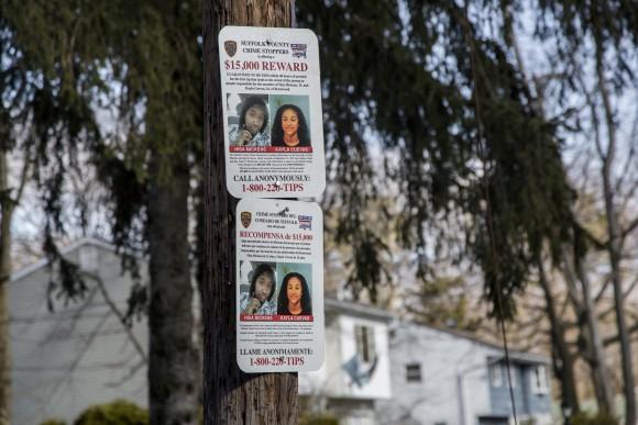 A sign offering a reward for information regarding the murder of Nisa Mickens and Kayla Cuevas, near Brentwood High School where they were students, in Brentwood, Long Island, N.Y., on March 29, 2017. (Samira Bouaou/The Epoch Times)