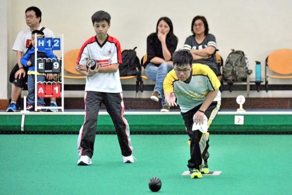 Rayson Law (delivering) from Yan Oi Tong Tin Ka Ping Secondary School defeated his schoolmate Gary Kwan in the final of the Hong Kong Inter-schools Lawn Bowls Competition on Monday, May 1, 2017, to lift the title. (Stephanie Worth)