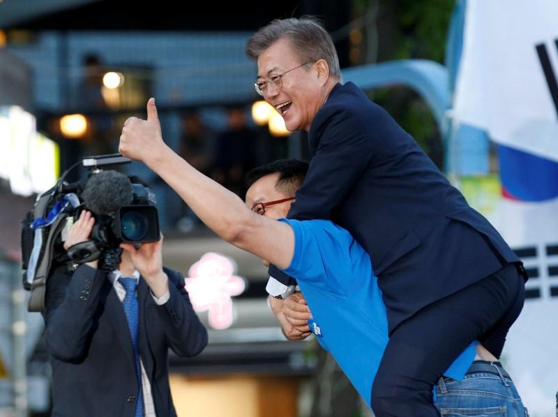 A supporter carries Moon Jae-in, presidential candidate of the Democratic Party of Korea, on his back during Moon's election campaign rally in Seoul, South Korea on May 6, 2017. (REUTERS/Kim Kyung-Hoon)