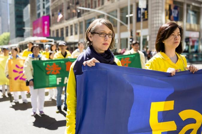 Thousands of Falun Gong practitioners march in a parade along 42nd Street in New York for World Falun Dafa Day on May 12, 2017. (Samira Bouaou/The Epoch Times)