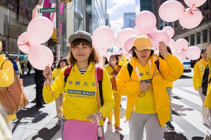 Thousands of Falun Gong practitioners march in a parade along 42nd Street in New York for World Falun Dafa Day on May 12, 2017. (Samira Bouaou/The Epoch Times)