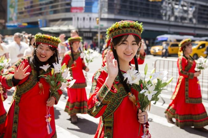 Falun Gong practitioners wearing ethnic Chinese clothes, march in a parade along 42nd Street in New York for World Falun Dafa Day on May 12, 2017. (Samira Bouaou/The Epoch Times)