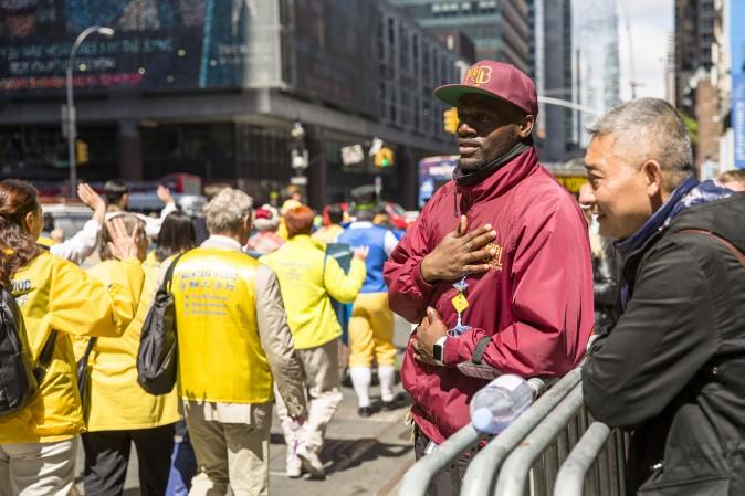 A man watches the World Falun Dafa Day parade in New York on May 12, 2017. (Samira Bouaou/The Epoch Times)