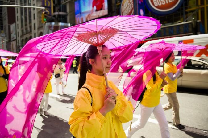 Thousands of Falun Gong practitioners march in a parade along 42nd Street in New York for World Falun Dafa Day on May 12, 2017. (Samira Bouaou/The Epoch Times)