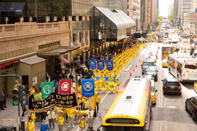 Thousands of Falun Gong practitioners march in a parade along 42nd Street in New York for World Falun Dafa Day on May 12, 2017. (Evan Ningn/The Epoch Times)