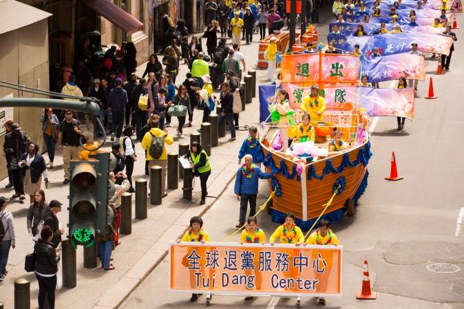 Thousands of Falun Gong practitioners march in a parade along 42nd Street in New York for World Falun Dafa Day on May 12, 2017. (Evan Ning/The Epoch Times)