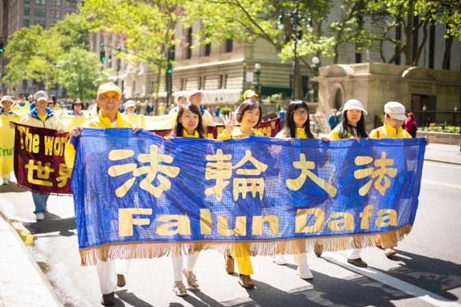 Thousands of Falun Gong practitioners march in a parade along 42nd Street in New York for World Falun Dafa Day on May 12, 2017. (Benjamin Chasteen/The Epoch Times)