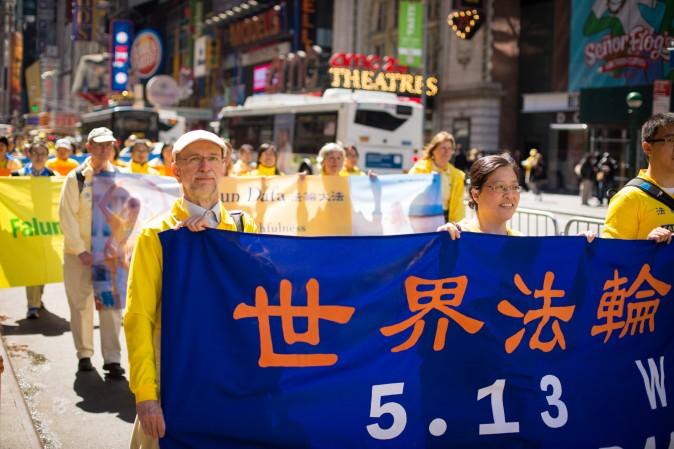 Thousands of Falun Gong practitioners march in a parade along 42nd Street in New York for World Falun Dafa Day on May 12, 2017. (Benjamin Chasteen/The Epoch Times)