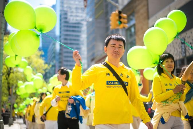 Thousands of Falun Gong practitioners march in a parade along 42nd Street in New York for World Falun Dafa Day on May 12, 2017. (Mihut Savu/The Epoch Times)