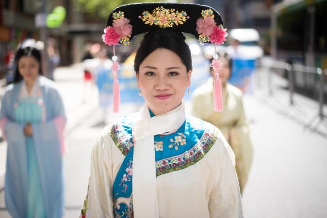A Falun Gong practitioner wears traditional Chinese clothing during a parade along 42nd Street in New York for World Falun Dafa Day on May 12, 2017. (Mihut Savu/The Epoch Times)