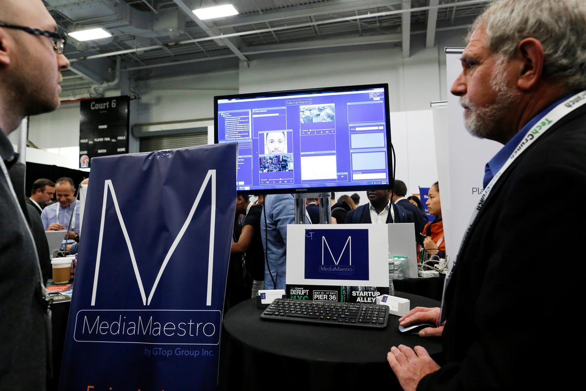 Gary Olson (R) of GTop Group gives a demonstration of their Anti-Terrorism and Situational Awareness technology platform to attendees during the TechCrunch Disrupt event in Manhattan, in New York City, NY on May 15, 2017. (REUTERS/Eduardo Munoz)