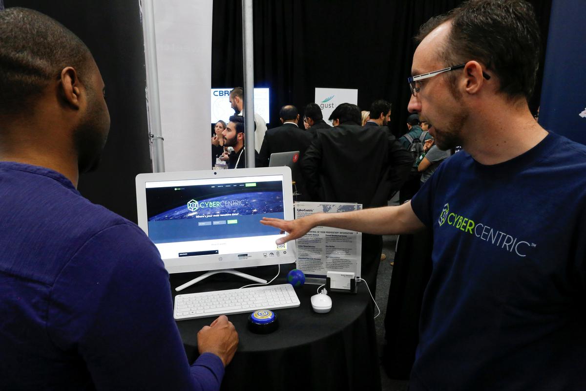 Weston Wheelehan (R) and Jeremiah Steptoe, CEO of CyberCentric, give a demonstration of their Cybersecurity platform to attendees during the TechCrunch Disrupt event in Manhattan on May 15, 2017. (REUTERS/Eduardo Munoz)