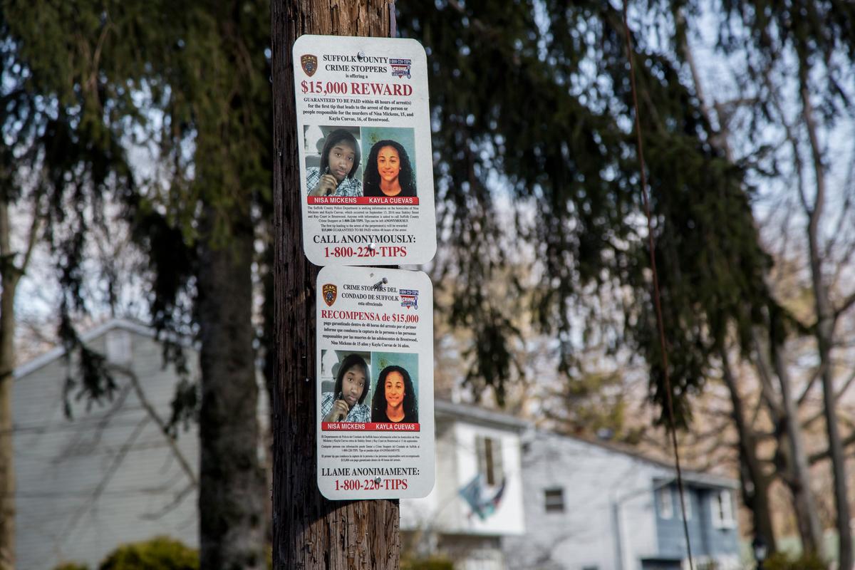 A sign offering a reward for information regarding the murders of Nisa Mickens and Kayla Cuevas, near Brentwood High School in Suffolk County, Long Island, N.Y., on March 29, 2017. (Samira Bouaou/The Epoch Times)