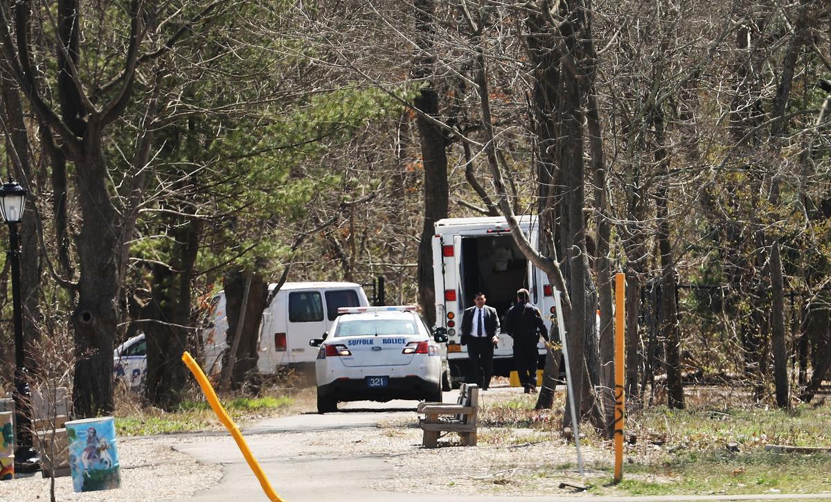 Police investigate the site where four young men were found murdered in a park in Central Islip, NY, on April 13, 2017. (Spencer Platt/Getty Images)