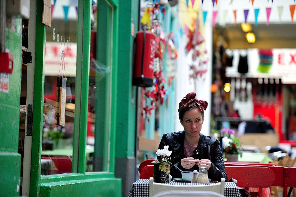 A woman relaxes at a cafe in Brixton Village, south London, on Oct. 17, 2013. (CARL COURT/AFP/Getty Images)