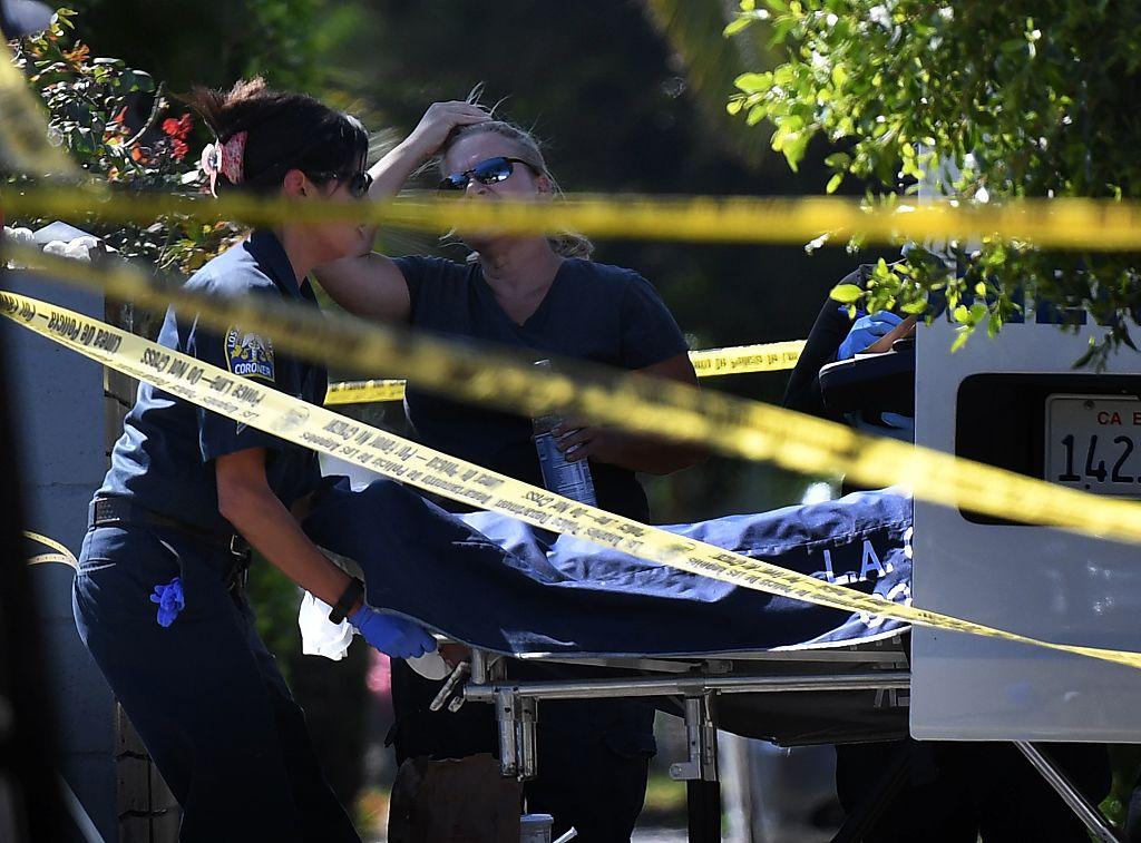 Los Angeles County coroner staff remove a body after three people were killed in a shooting at a pop-up Jamaican restaurant in Los Angeles on Oct. 15, 2016.   (MARK RALSTON/AFP/Getty Images)