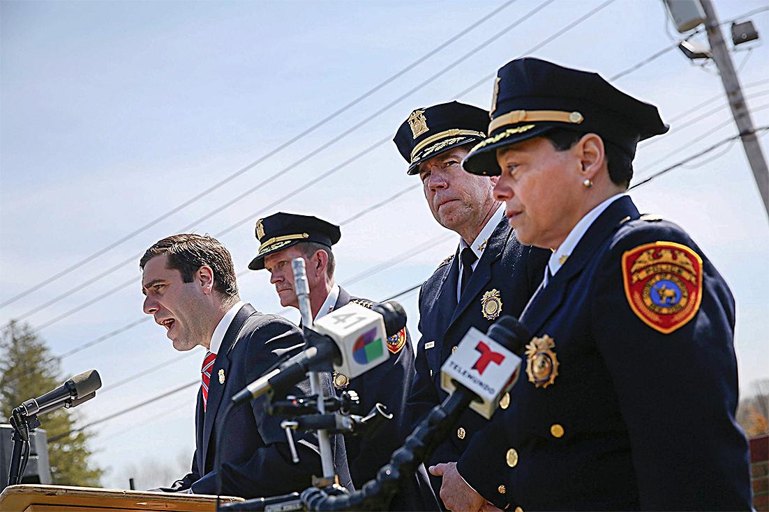 Suffolk County Police Commissioner Timothy Sini (L) at a news conference, where he offered a $25,000 reward for information leading to an arrest in the killings of four young men, in Central Islip, N.Y., on April 13. (SPENCER PLATT/GETTY IMAGES)