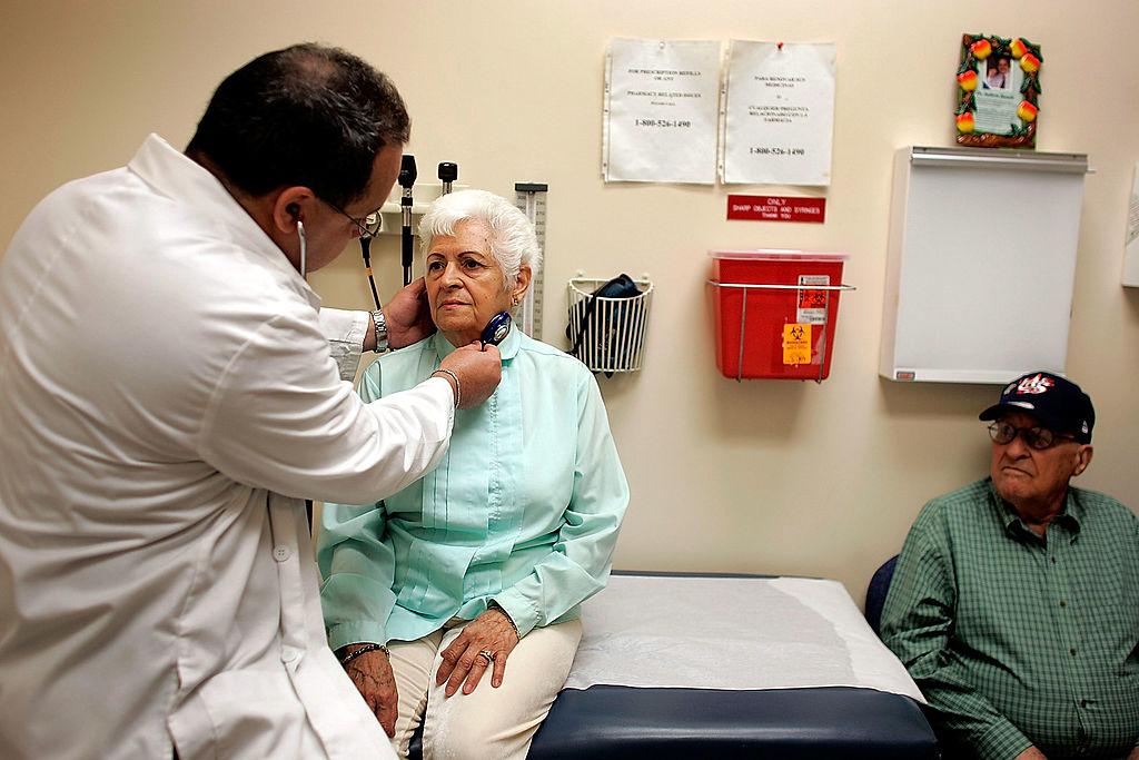 Dr. Ausberto Bianchi checks Ofelia Perez during an exam at the CAC-Florida medical center in Miami, Fla., on March 22, 2007. (Joe Raedle/Getty Images)
