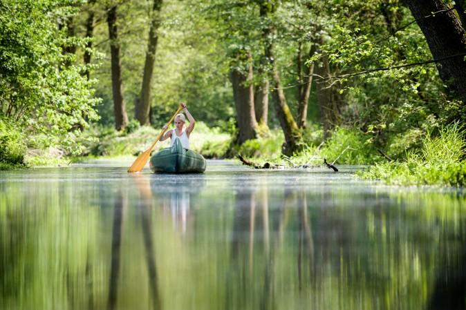 A young woman paddles a canoe on a creek in Loecknitz, Germany, on May 19, 2017. (Thomas Lohnes/Getty Images)