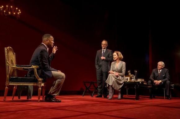 (L–R) Paul (Corey Hawkins) cons his way into the lives of the affluent couple Flan (John Benjamin Hickey) and Ouisa (Allison Janney) while their friend Geoffrey (Michael Siberry) looks on, in "Six Degrees of Separation." (Joan Marcus)