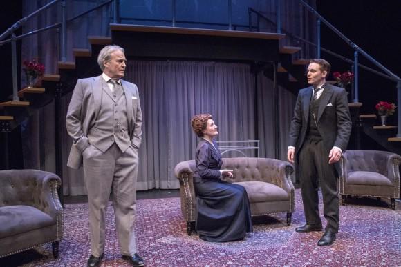 (L–R) Sir James Farringdon (Wynn Harmon), Lady Farringdon (Deanne Lorette) and their son Bob (Ari Brand). The first act has the characters all costumed in shades of gray. (Richard Termine)