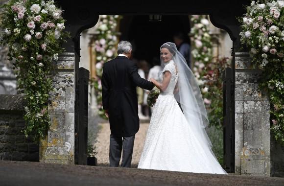 Pippa Middleton (R) is escorted by her father Michael Middleton as she arrives for her wedding to James Matthews at St Mark's Church on May 20, 2017 in Englefield Green, England. (Justin Tallis - WPA Pool/Getty Images)