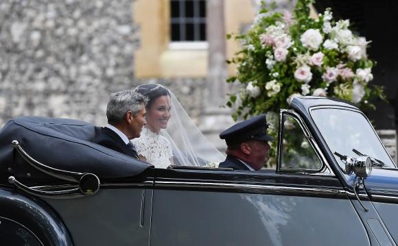 Pippa Middleton arrives with her father Michael Middleton in a 1951 Jaguar Mk V car, for her wedding ceremony at St Mark's Church as the bridesmaids and pageboys walk ahead on May 20, 2017 in Englefield Green, England. (Justin Tallis - WPA Pool/Getty Images)