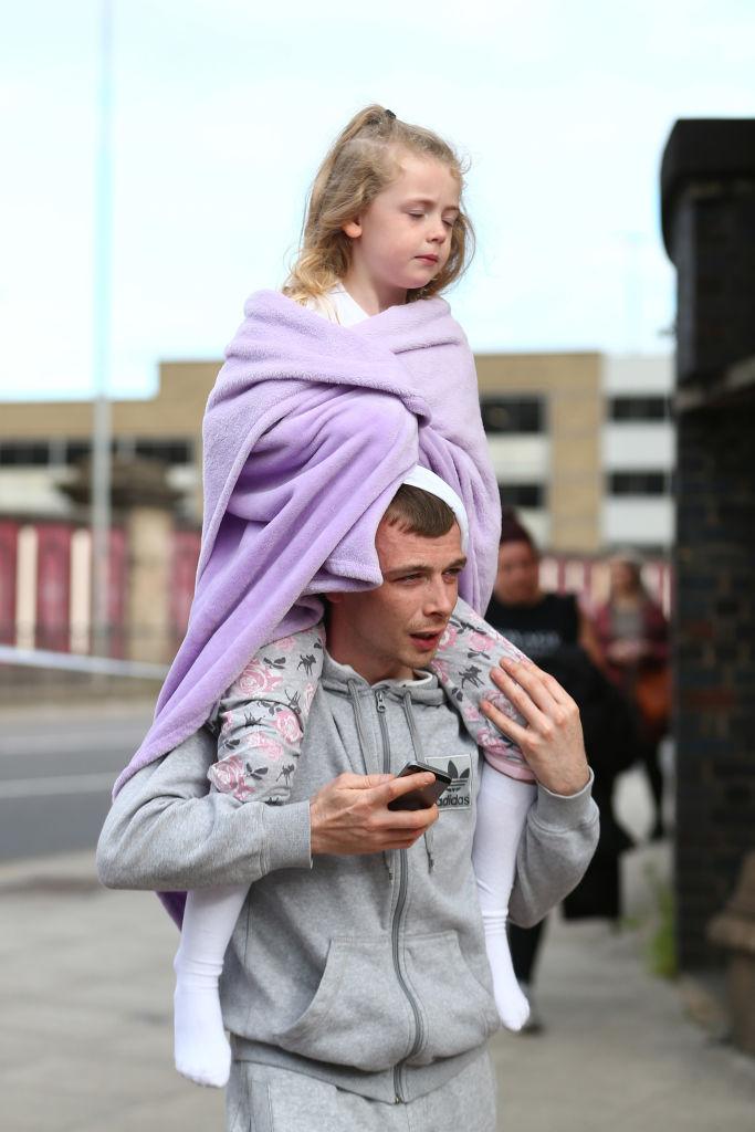 A man carries a young girl on his shoulders in Manchester, England on May 23, 2017. (Dave Thompson/Getty Images)