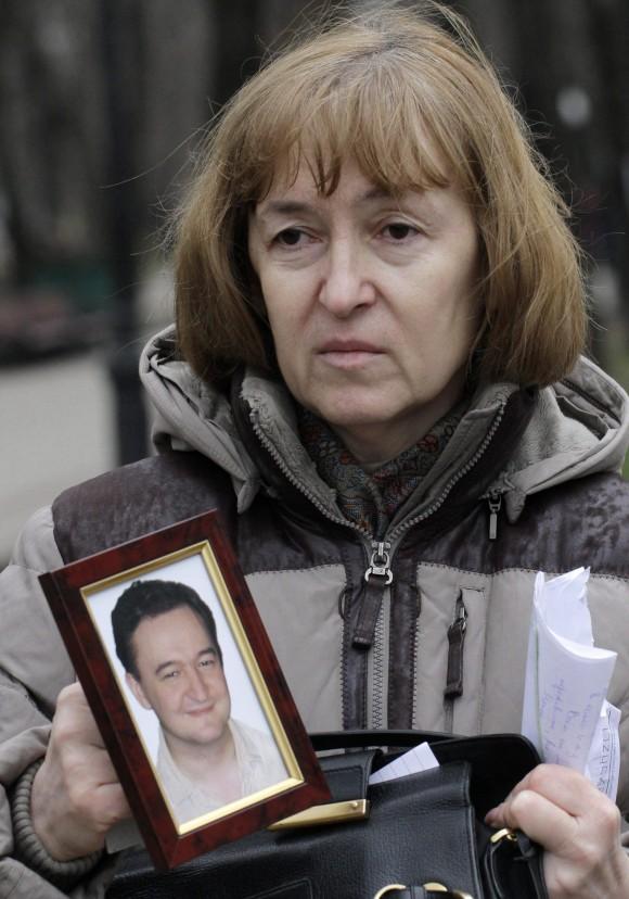 Nataliya Magnitskaya, mother of lawyer Sergei Magnitsky, holds a photo of her son in Moscow on Nov. 30, 2009. Magnitsky died in prison after accusing government officials of tax fraud to the tune of $230 million. (AP Photo/Alexander Zemlianichenko)