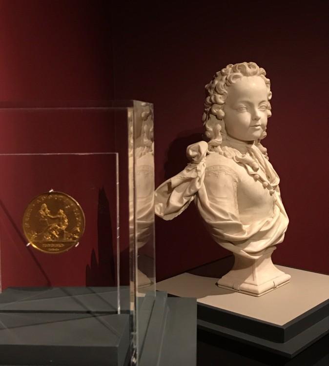 Medal depicting Antoine Coysevox (1640–1720), dated 1711, by Thomas Bernard (1650–1713). Gilt copper alloy, struck. Scher Collection, promised gift to The Frick Collection, and Louis XV as a child of 6, 1716, by Antoine Coysevox (1640–1720). Marble, The Frick Collection, gift of Dr. and Mrs. Ira H. Kaufman, 1990. (Milene Fernandez/The Epoch Times)