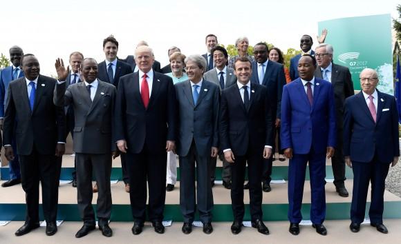 Front row, L-R: Kenya's President Uhuru Kenyatta, Guinea's President Alpha Conde, U.S. President Donald Trump, Italian Prime Minister Paolo Gentiloni, French President Emmanuel Macron, Niger's President Mahamadou Issoufou and Tunisian President Beji Caid Essebsi pose for a family photo with other participants of the G7 summit during the Summit of the Heads of State and of Government of the G7, the group of most industrialized economies, plus the European Union, in Taormina, Sicily, Italy, May 27, 2017. (Reuters//Stephane de Sakutin/Pool)
