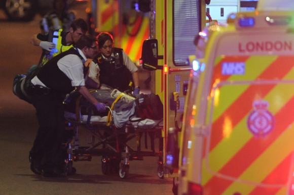 Police officers and members of the emergency services attend to a person injured in a terror attack on London Bridge in central London on June 3, 2017. (Daniel Sorabji/AFP/Getty Images)
