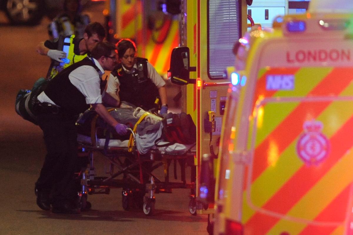 Police officers and members of the emergency services attend to a person injured in a terror attack on London Bridge in central London on June 3, 2017. (Daniel Sorabji/AFP/Getty Images)