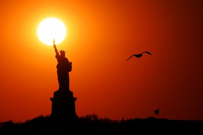 The sun sets behind the Statue of Liberty in New York City on June 02, 2017. (Michael Heiman/Getty Images)