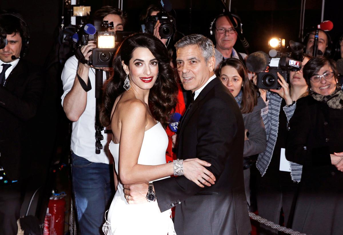 Actor George Clooney and his wife Amal arrive at the 42nd Cesar Awards ceremony in Paris, France on Feb. 24, 2017. (REUTERS/Gonzalo Fuentes)
