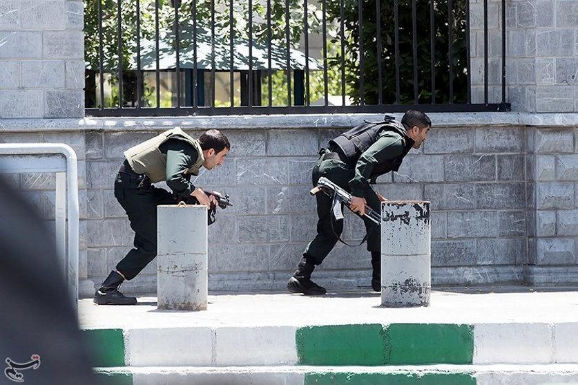 Members of Iranian forces take cover during an attack on the Iranian parliament in central Tehran, Iran, June 7, 2017. Tasnim News Agency/Handout via REUTERS