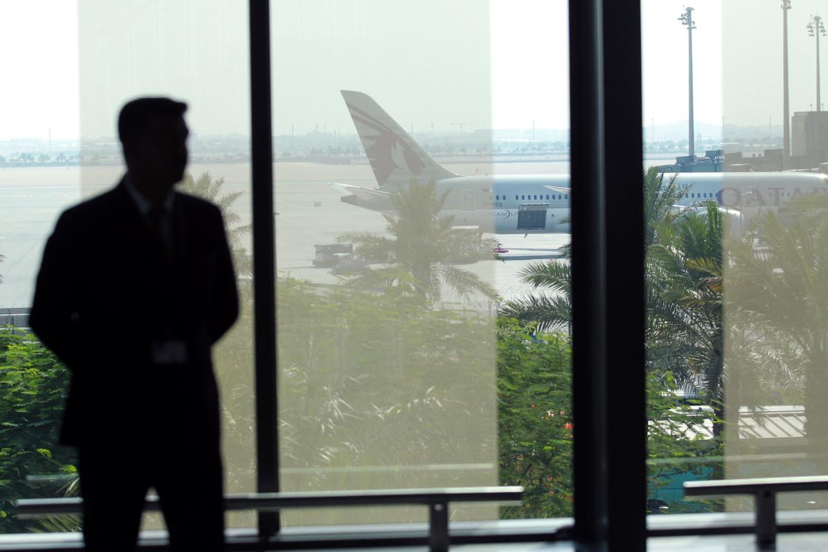 A staff memeber stands at Hamad International Airport in Doha, Qatar on June 7, 2017. (REUTERS/Naseem Zeitoon)