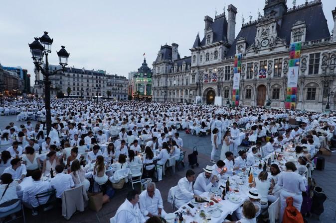Participants dressed in white attend a "Diner en Blanc" (Dinner in White) in front of the City Hall in Paris on June 8, 2017. Diner en Blanc, the most chic picnic gathering thousands of participants, takes place every year at a surprise location disclosed at the last minute to the participants. (THOMAS SAMSON/AFP/Getty Images)