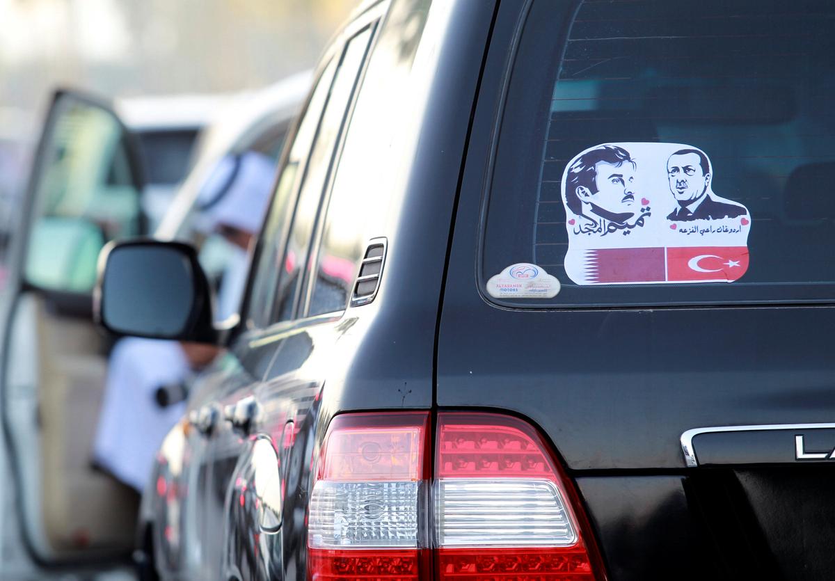 The pictures of Qatar's Emir Sheikh Tamim Bin Hamad Al-Thani (L) and Turkish President Tayyip Erdogan are seen on a car during a demonstration in support of him in Doha, Qatar on June 11, 2017. (REUTERS/Naseem Zeitoon)