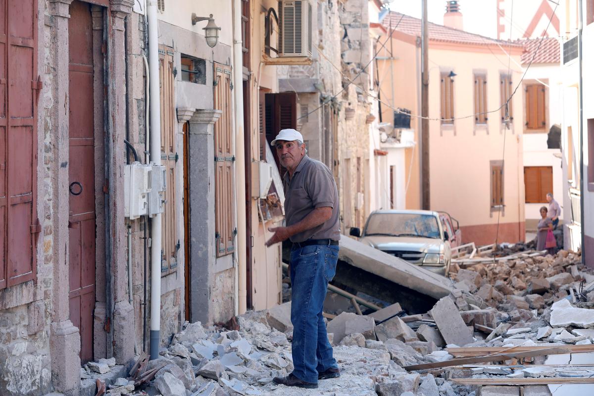 A man stands among damaged buildings at the village of Vrissa on the Greek island of Lesbos, Greece, after a strong earthquake shook the eastern Aegean on June 12, 2017. (REUTERS/Giorgos Moutafis)