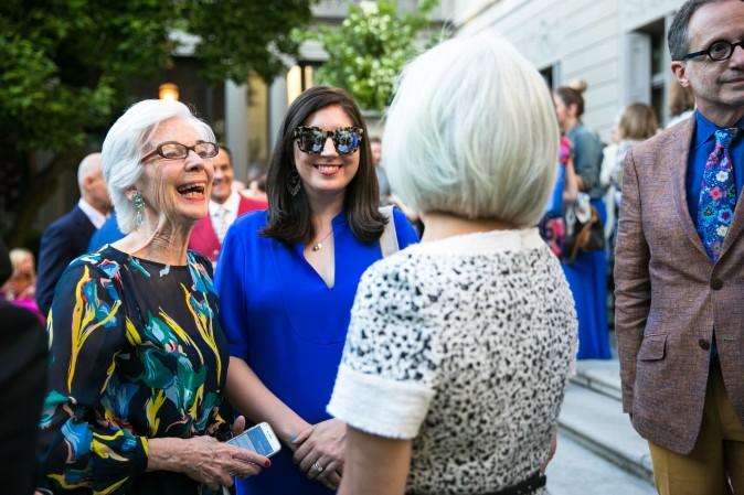 Susan Grace Galassi, senior curator for The Frick (L), chats with guests. (Benjamin Chasteen/The Epoch Times)
